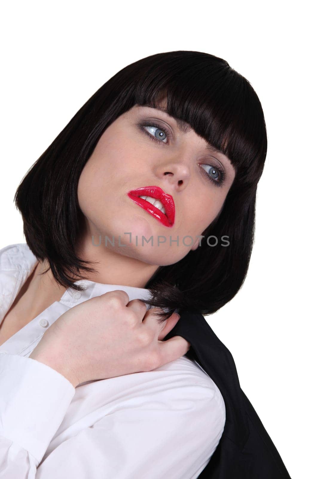 Studio portrait of a businesswoman holding her jacket over her shoulder