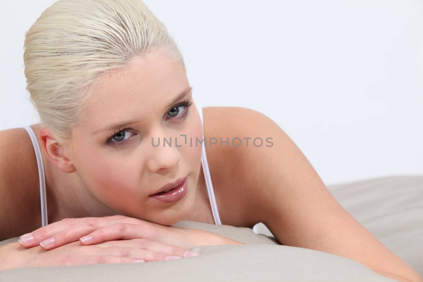 Blonde woman lying in bed