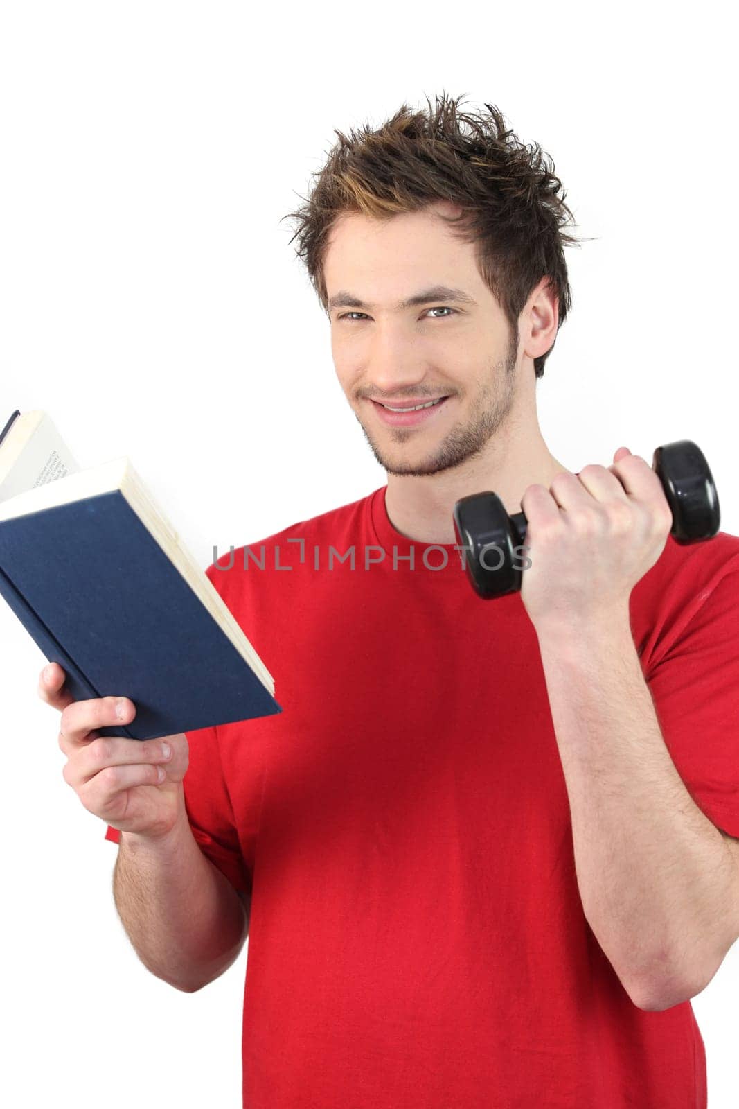 Man reading book whilst lifting weights