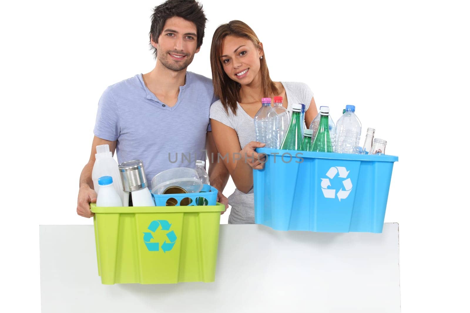 Couple recycling plastic bottles
