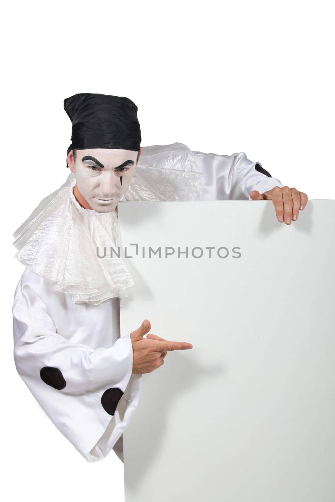 Man dressed as clown with message board