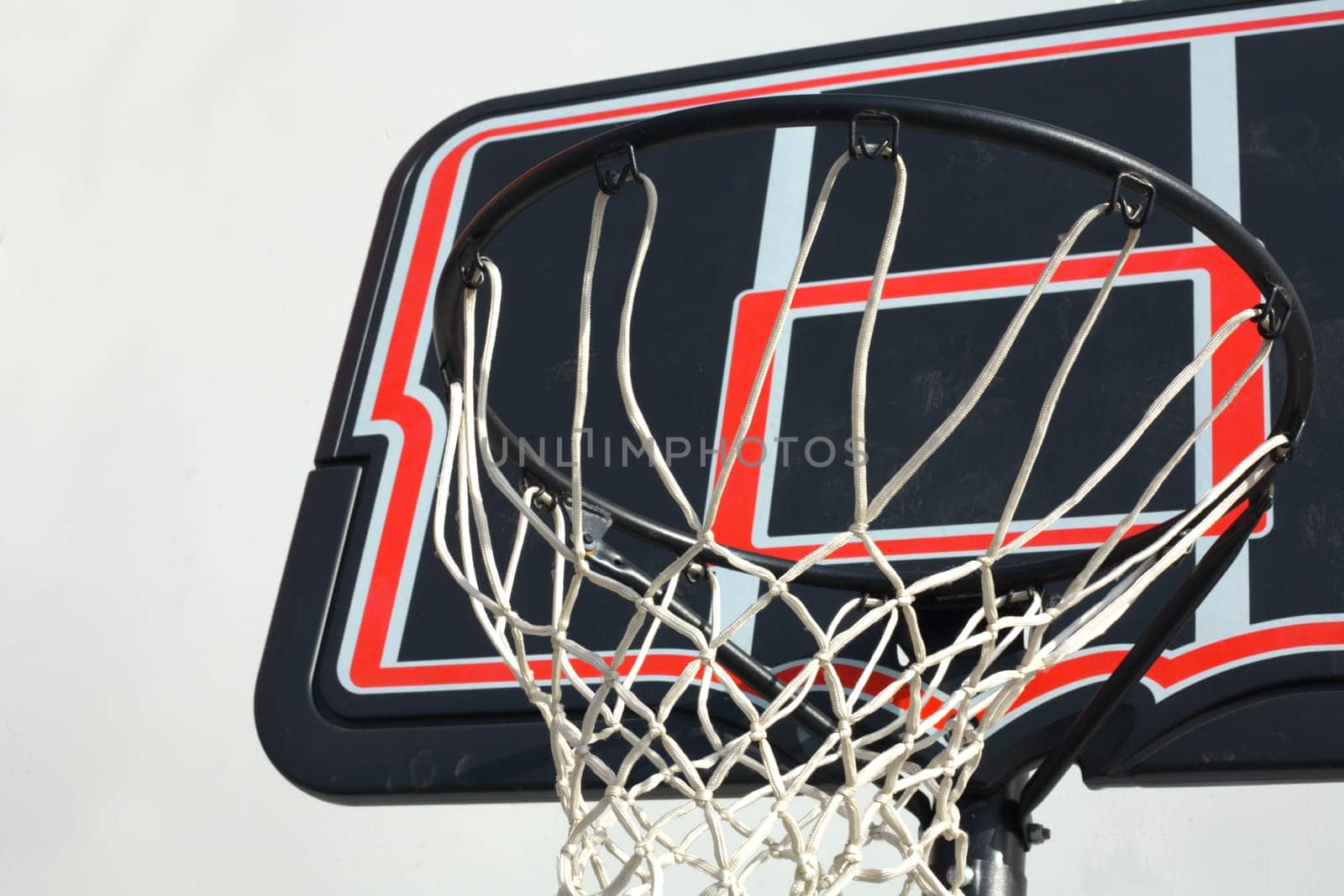 Black and red basketball hoop isolated over white blackground