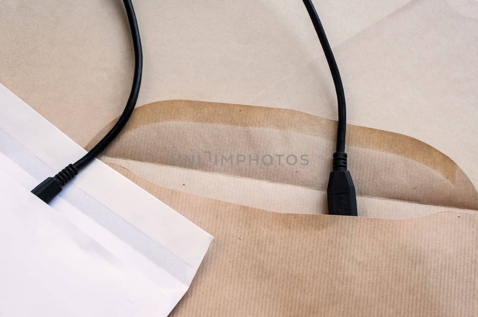 Two paper envelopes symbolically connected with interface cable
