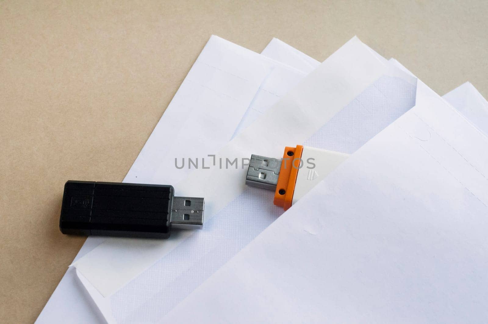Stack of white envelopes and USB flash memory drives as concept