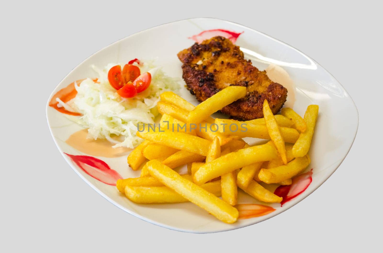White plate with floral pattern on it a schnitzel with fries and salad against a white background