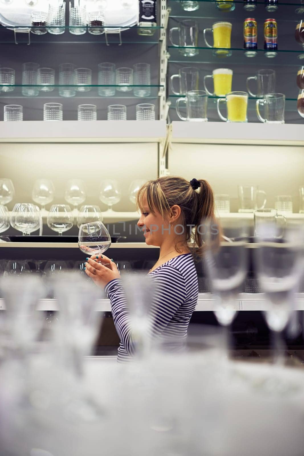 young hispanic woman shopping for furniture, glasses, dishes and home decor in store