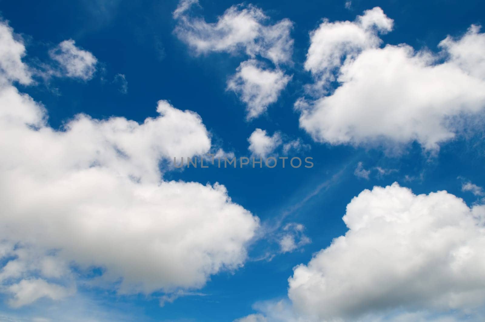 Blue sky with cotton like clouds