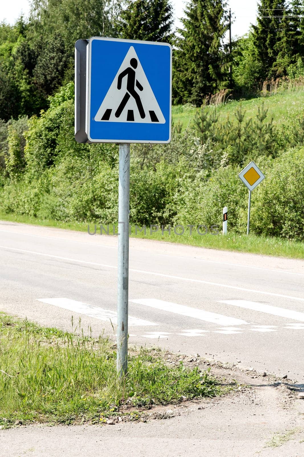Road  sign with zebra pattern pedestrian crossing