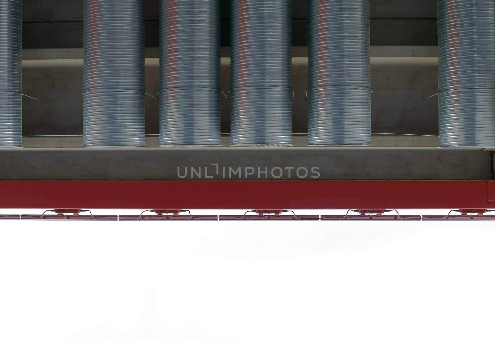 The photograph of vent pipes from a roof edge.