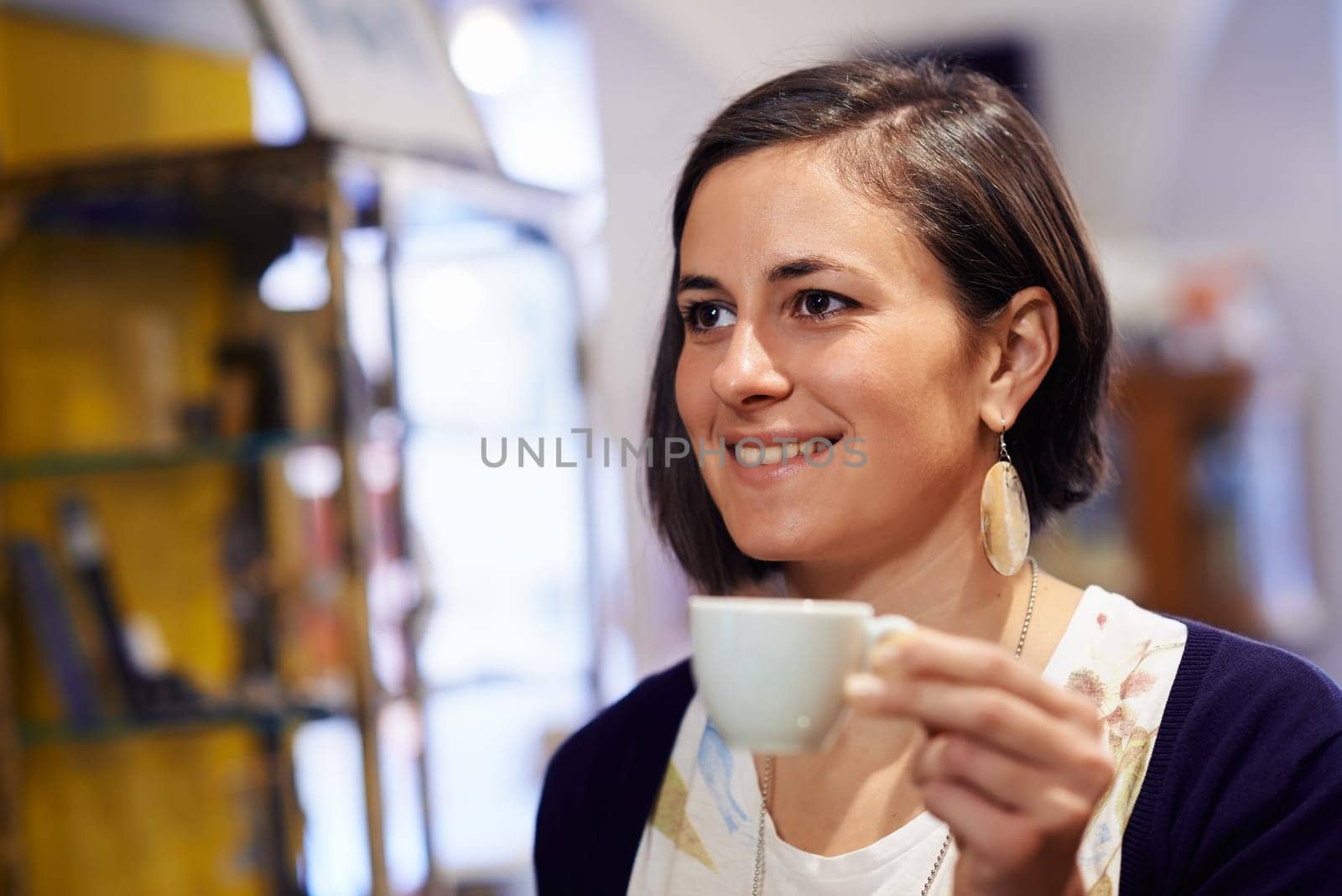 People in cafeteria with woman drinking espresso coffee and holding cup