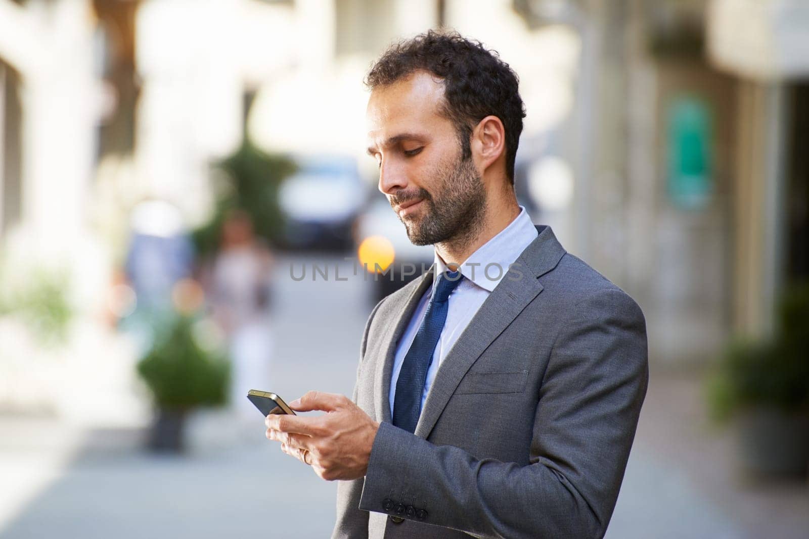 Happy people with businessman on the phone typing text message in city street