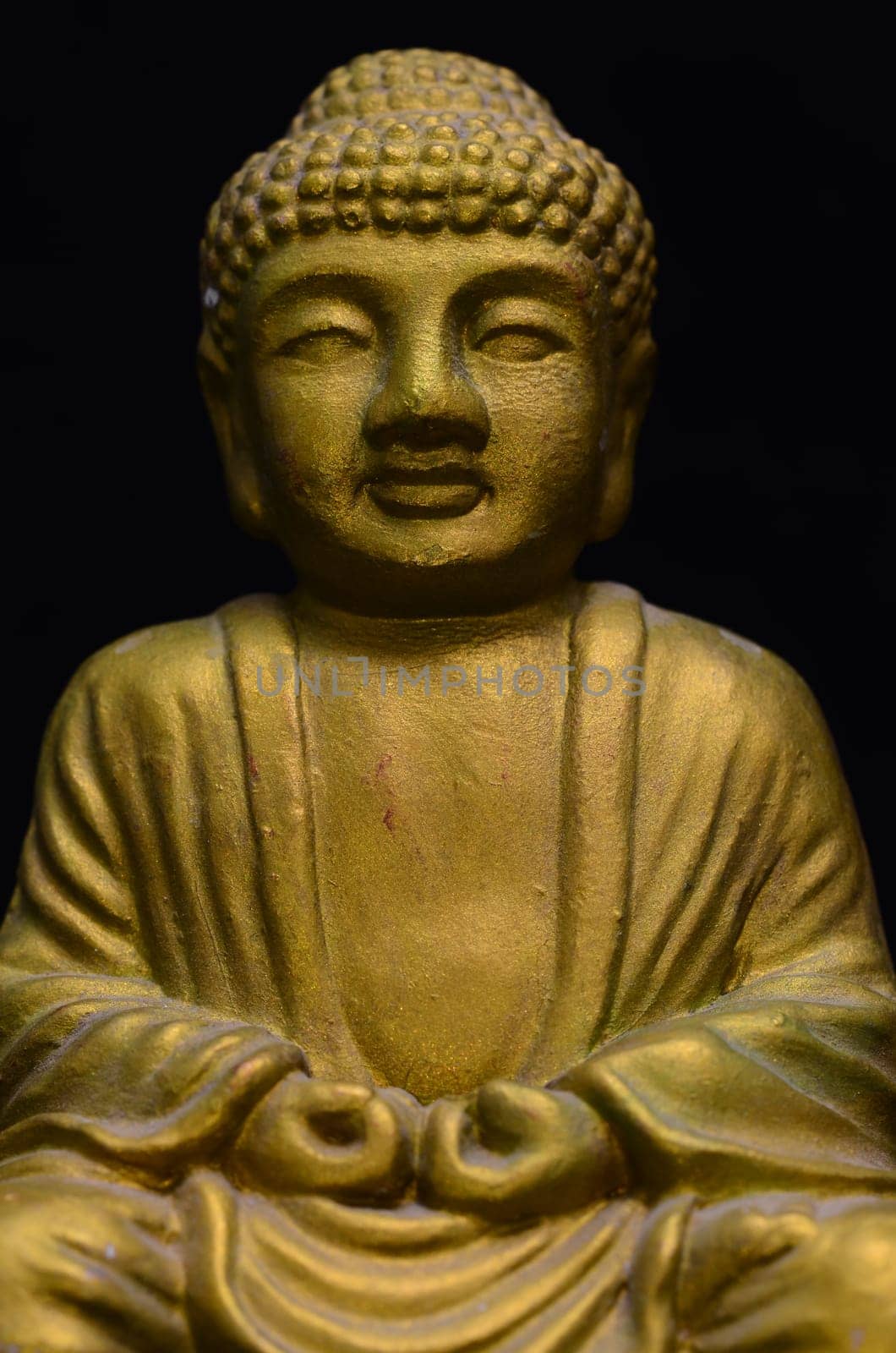 Golden Buddha Statue on a Black Background