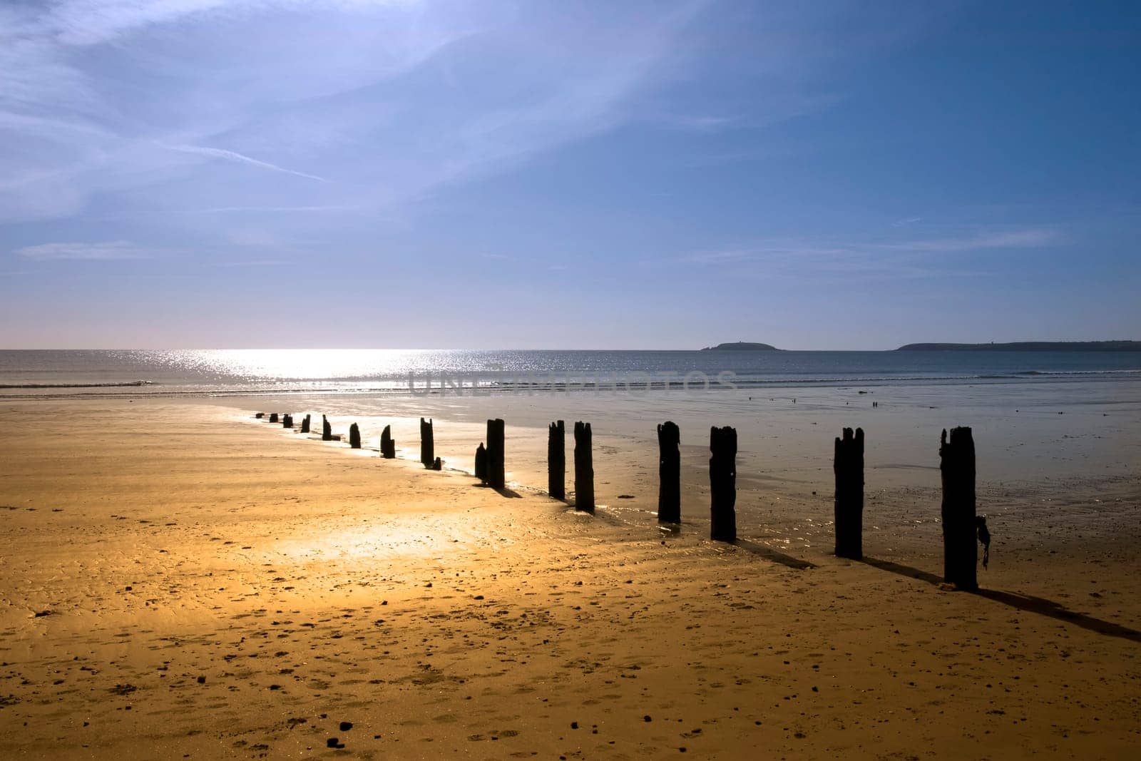 sunshine over the beach breakers in Youghal county Cork Ireland on a summers day
