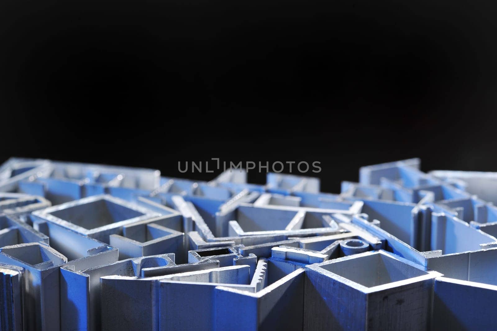 many different aluminium profile strips in blue spotlight