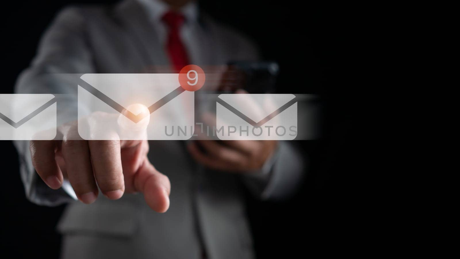 Businessman hand touching email on virtual screen. New email notification concept for business email communication and digital marketing. The inbox receives electronic message notifications. by Unimages2527