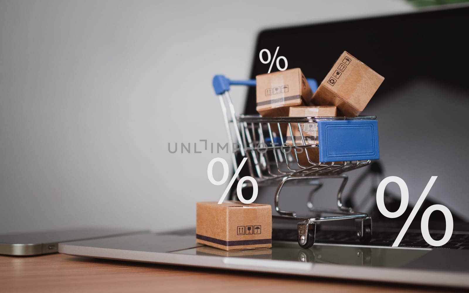 Sale percentage with shopping cart and boxes placed on computer keyboard. Online shopping concept, special price products, Special offers and promotions