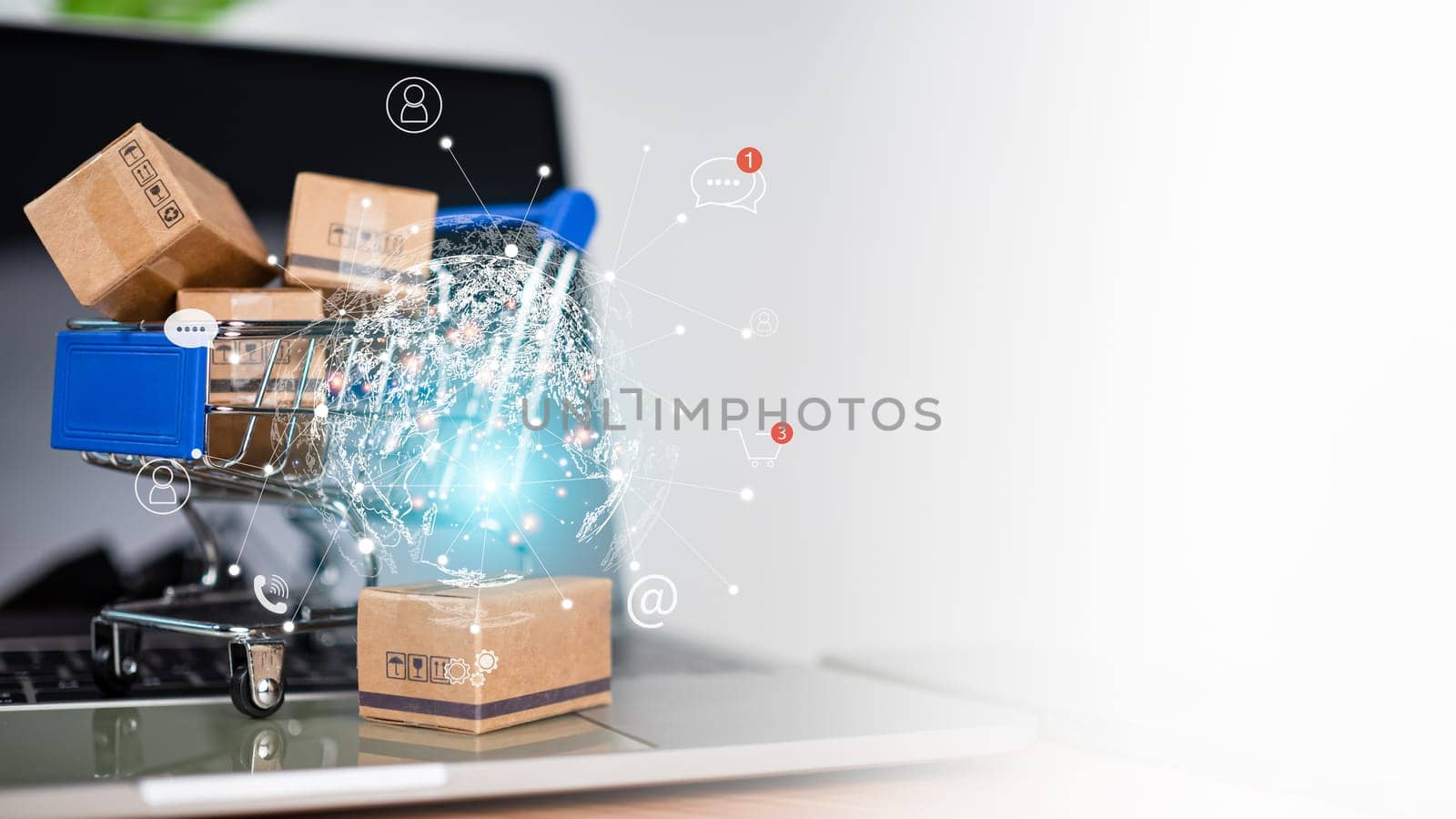 Shopping cart and product boxes with e-commerce network on laptop computer on white background and copy space. Represents online shopping market platform website and online payment concepts. by Unimages2527