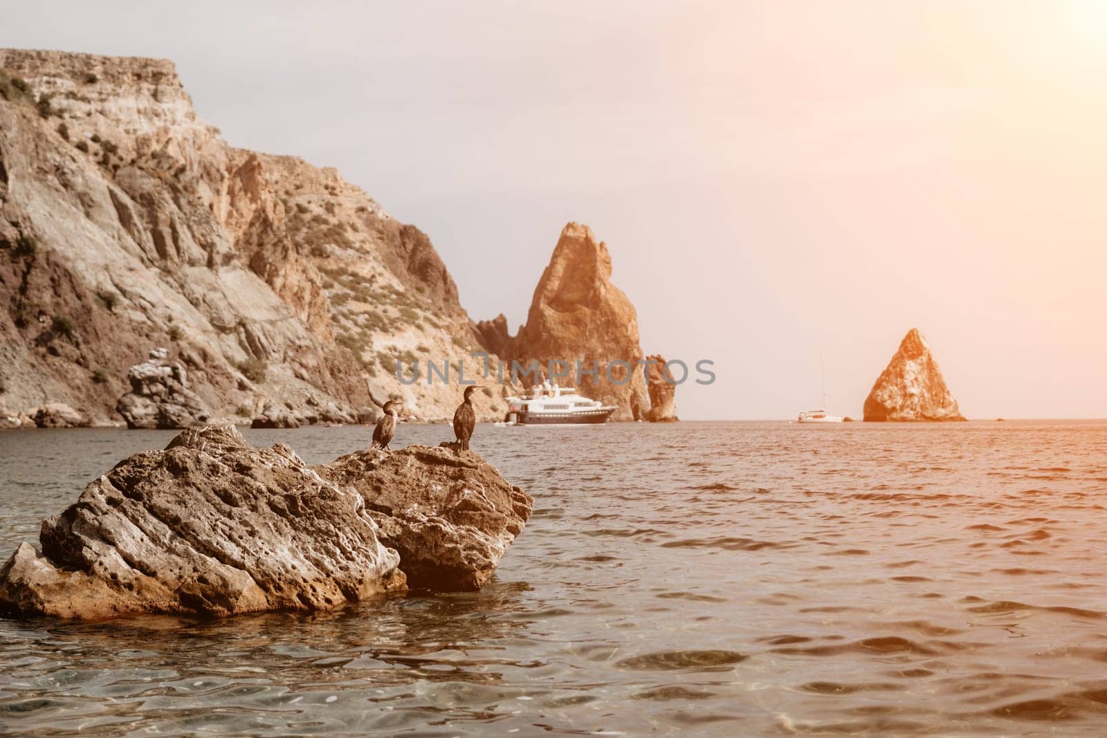 Aerial panoramic view of beautiful sunset above sea. Beautiful seascape. Sun glare, small waves on the water surface. Evening. Horizon. Nobody. No people. Copy space. Never-ending beauty of nature