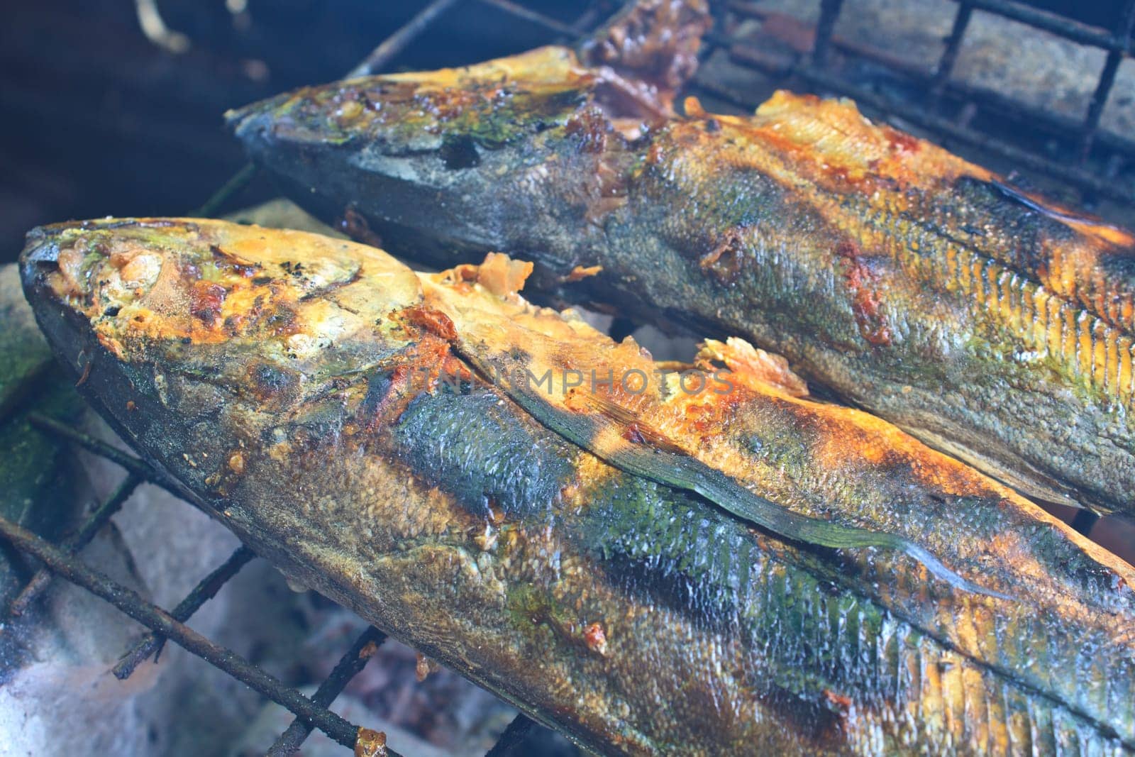 Cooking of salted fish on a grill stove