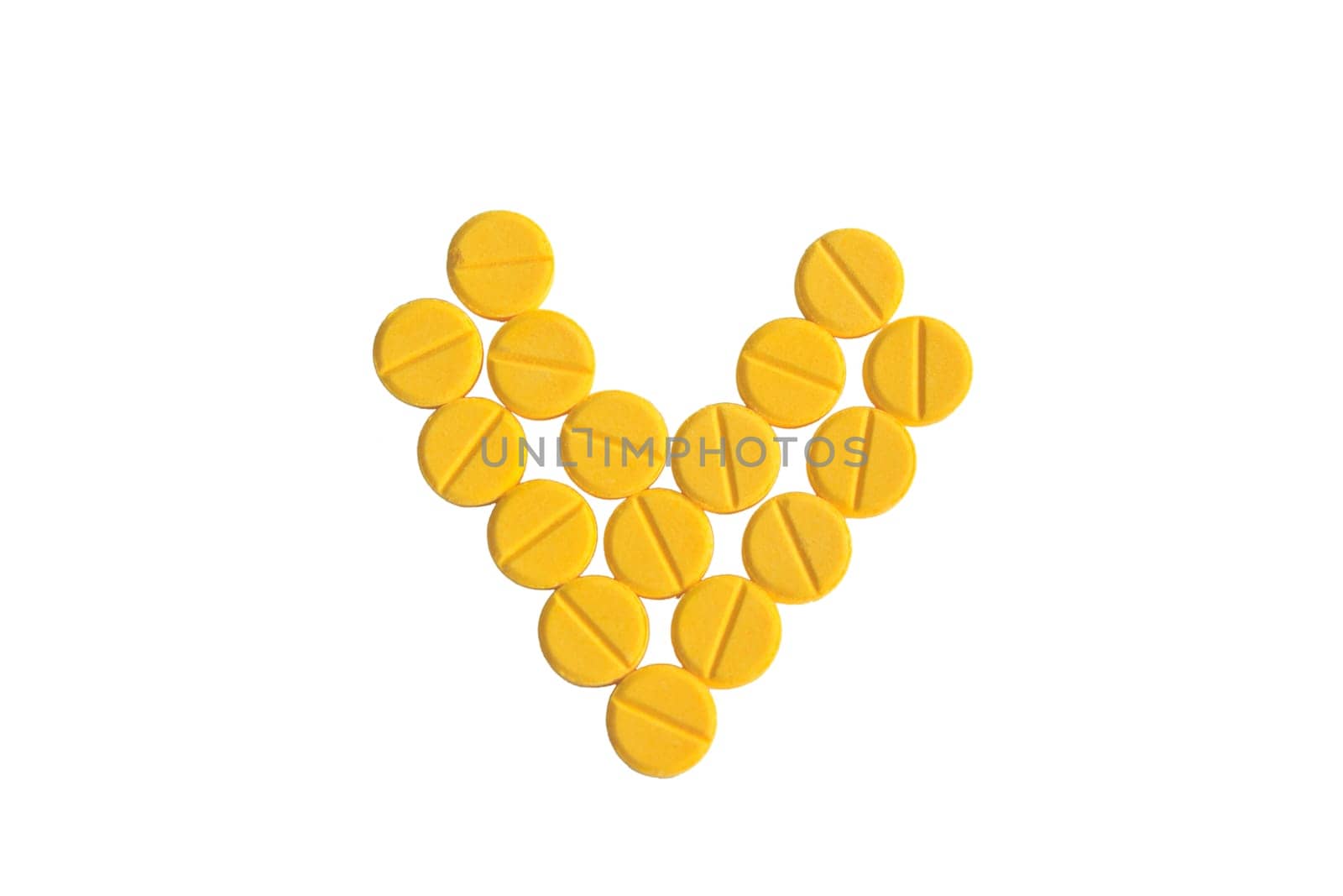 heart shaped of yellow medicine on the white background