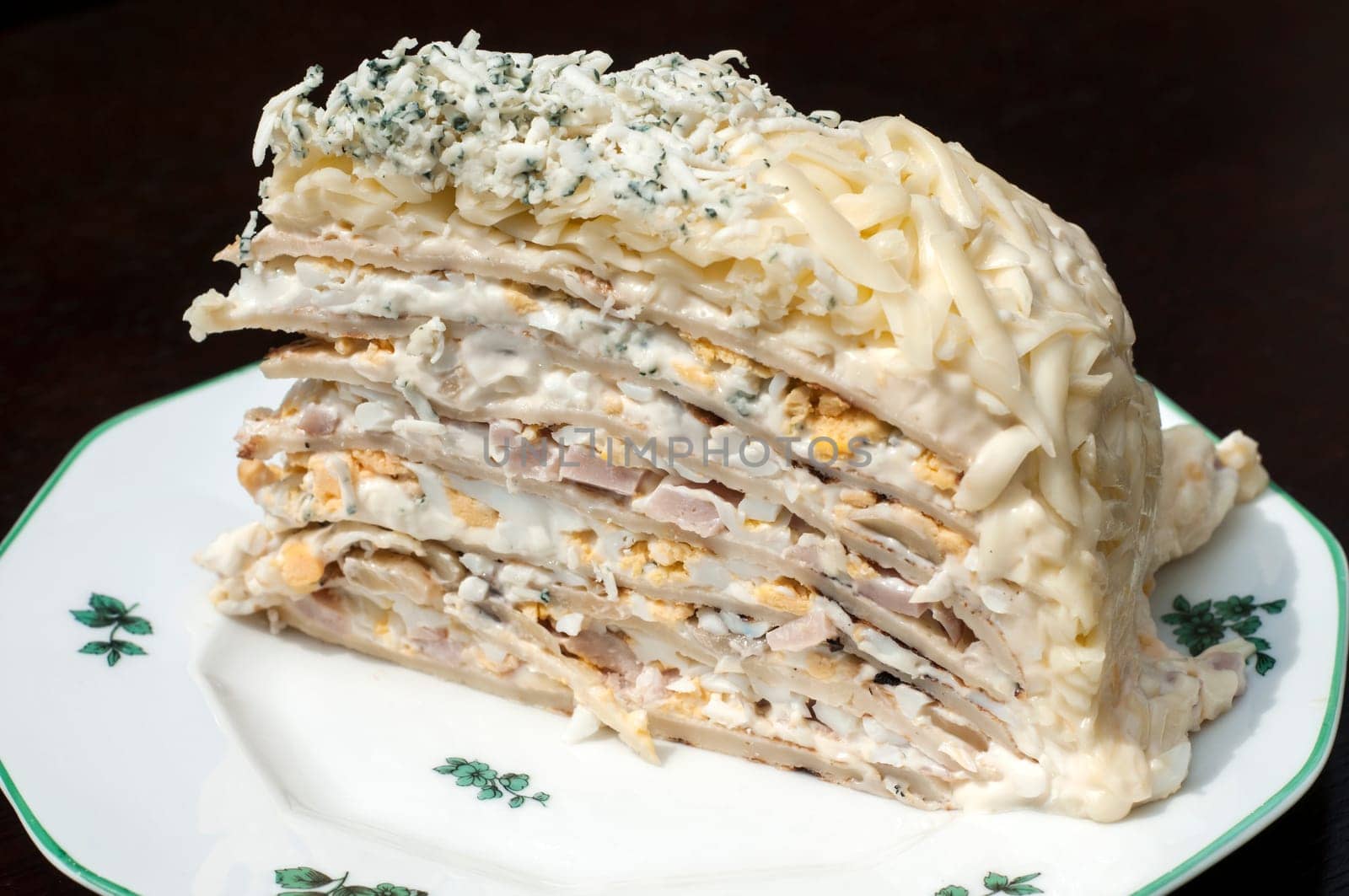Homemade salty pancake cake piece in plate