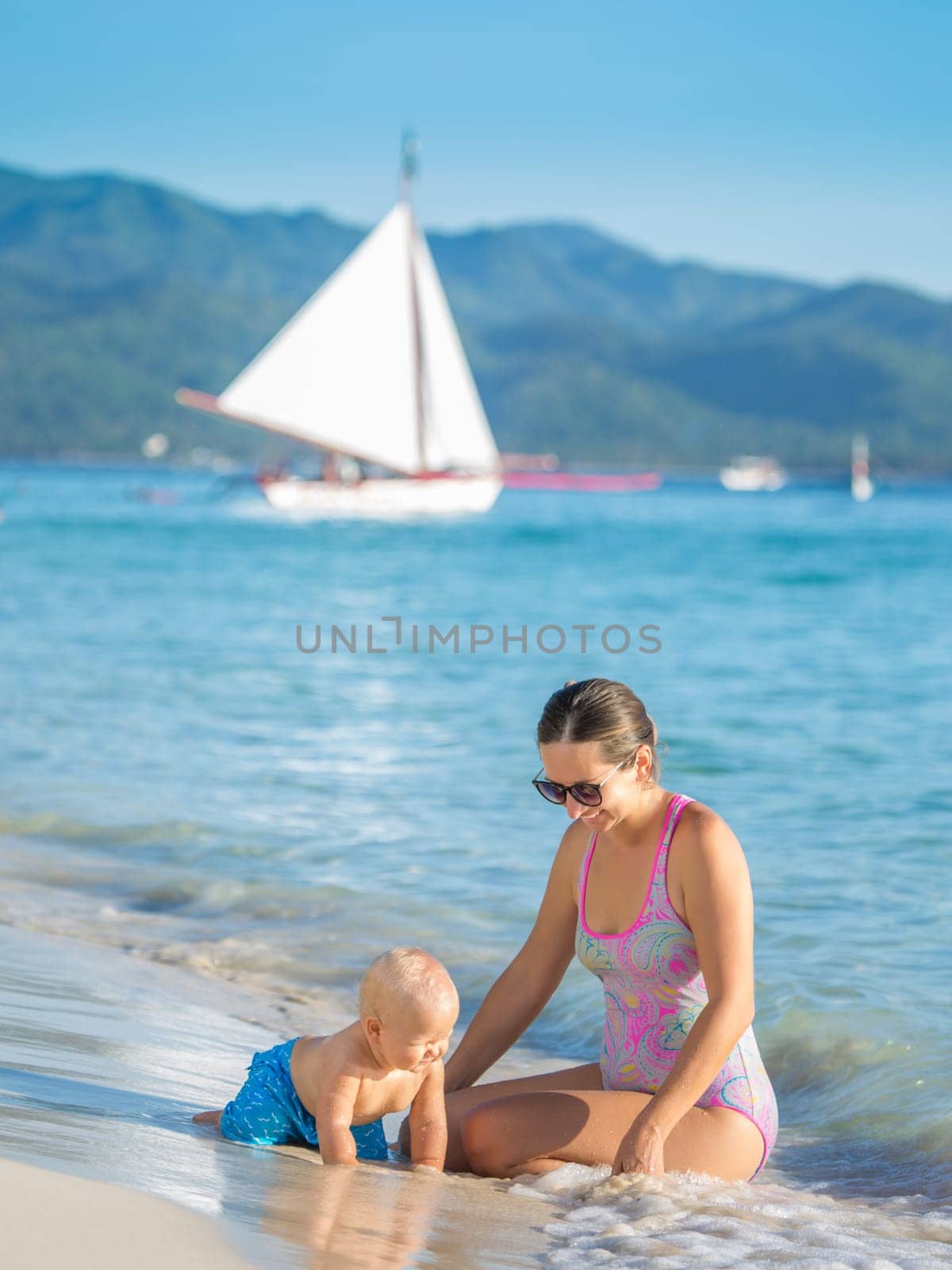 Baby and mother on the tropical beach