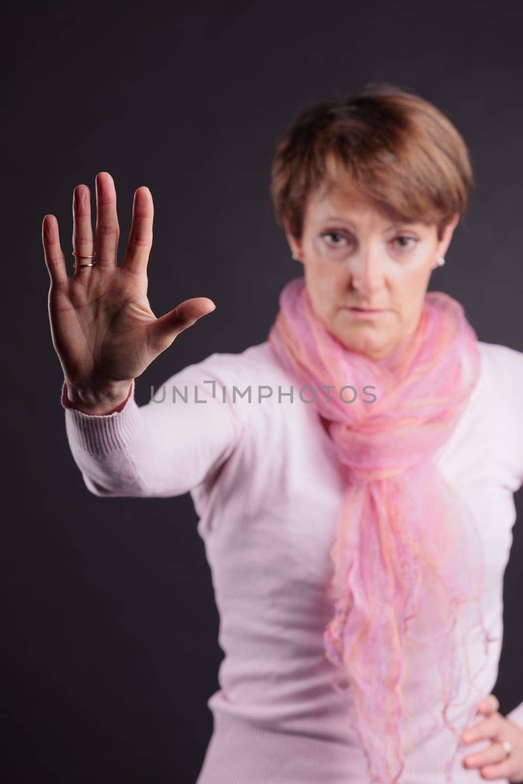 mature woman with a raised hand meaning you can't go further