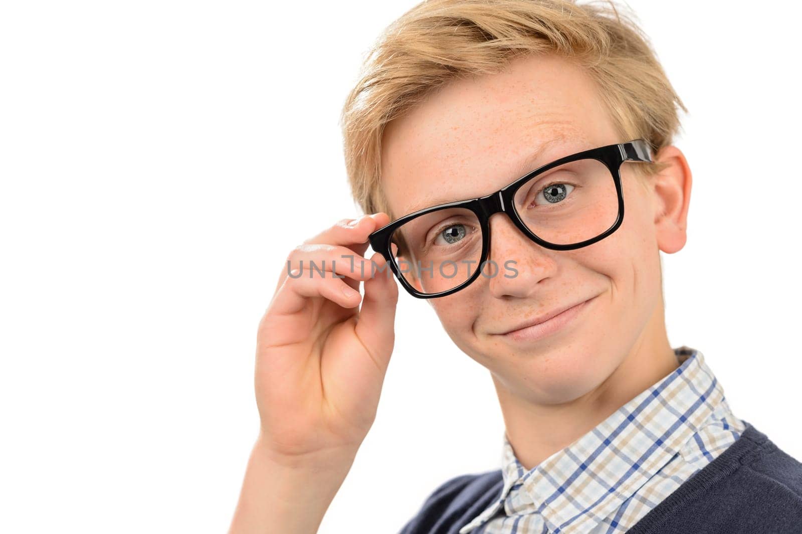 Confident teenage nerd boy holding geek glasses against white background