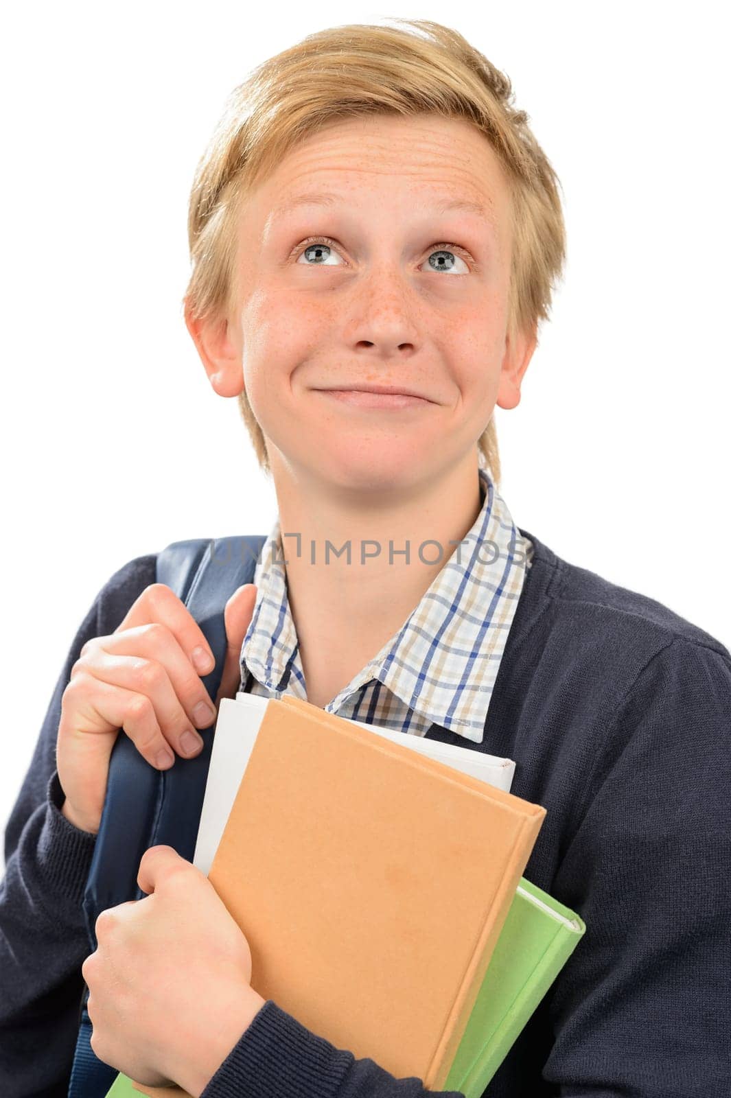 Thoughtful teenage student boy holding books against white background