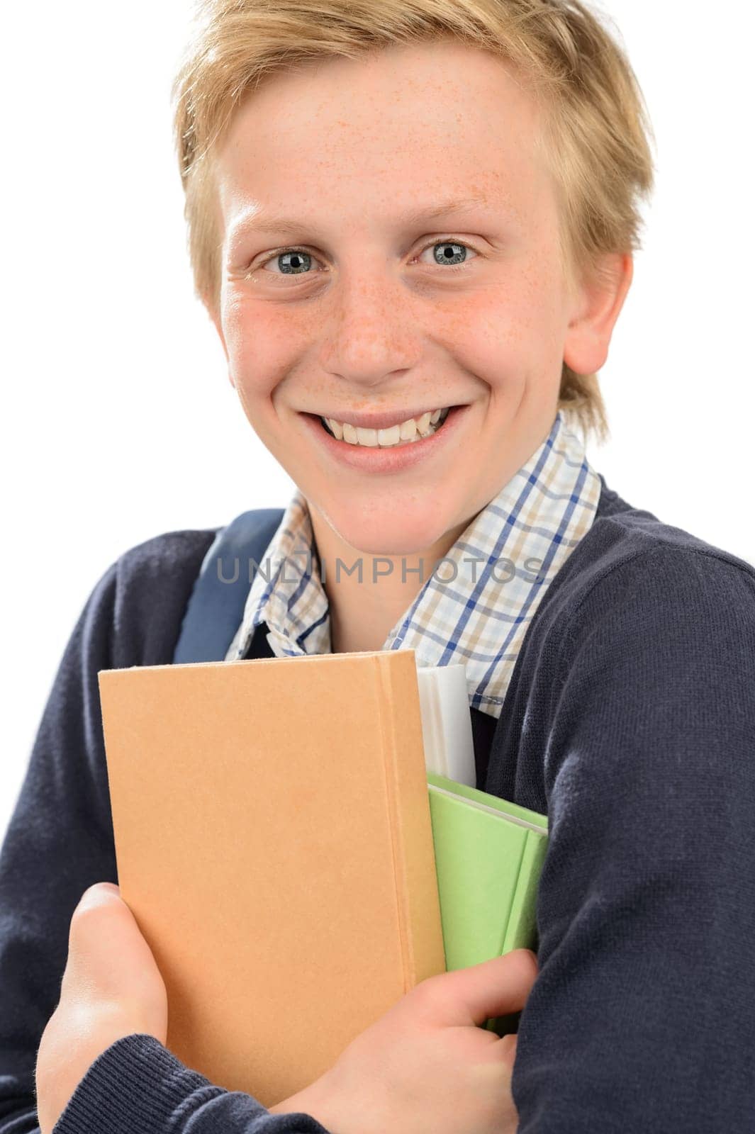 Cheerful teenage student  boy holding books against white background