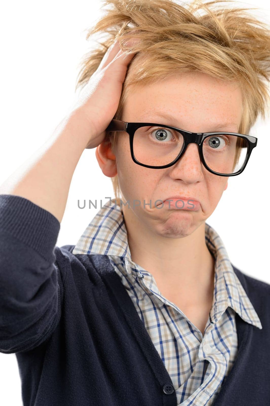 Frustrated teenage nerd boy in geek glasses against white background