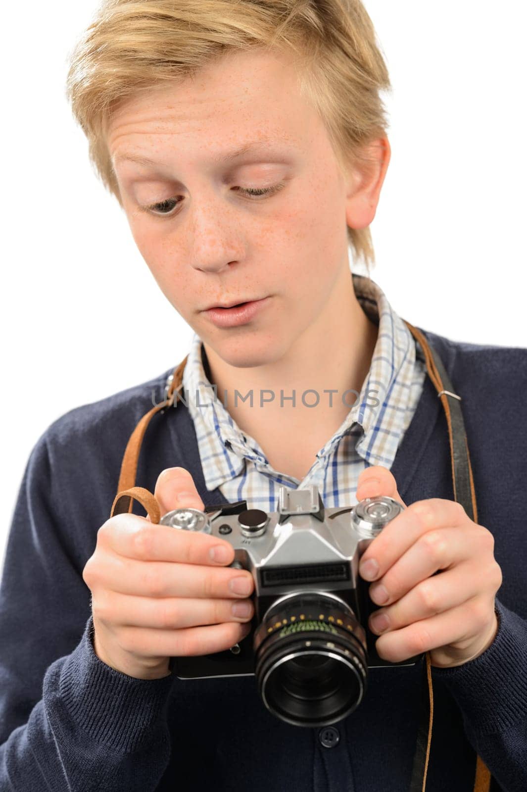 Teenage boy using retro camera against white background