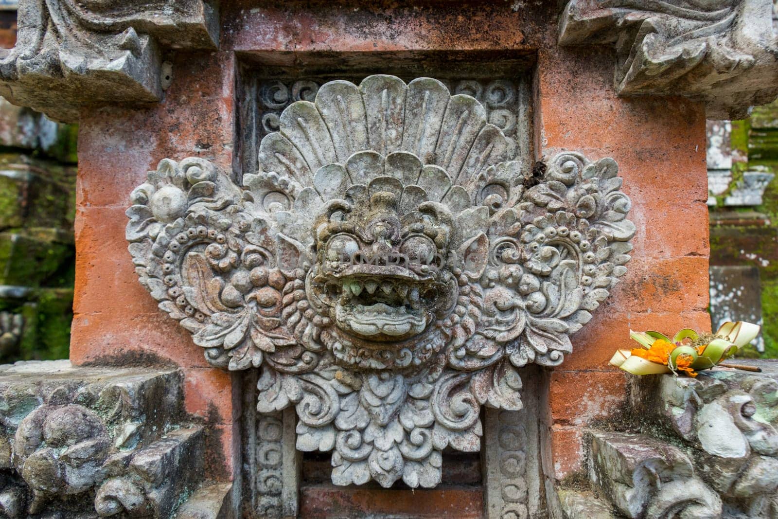 Artful carvings in stone stonemasonry in a green complex in Bali