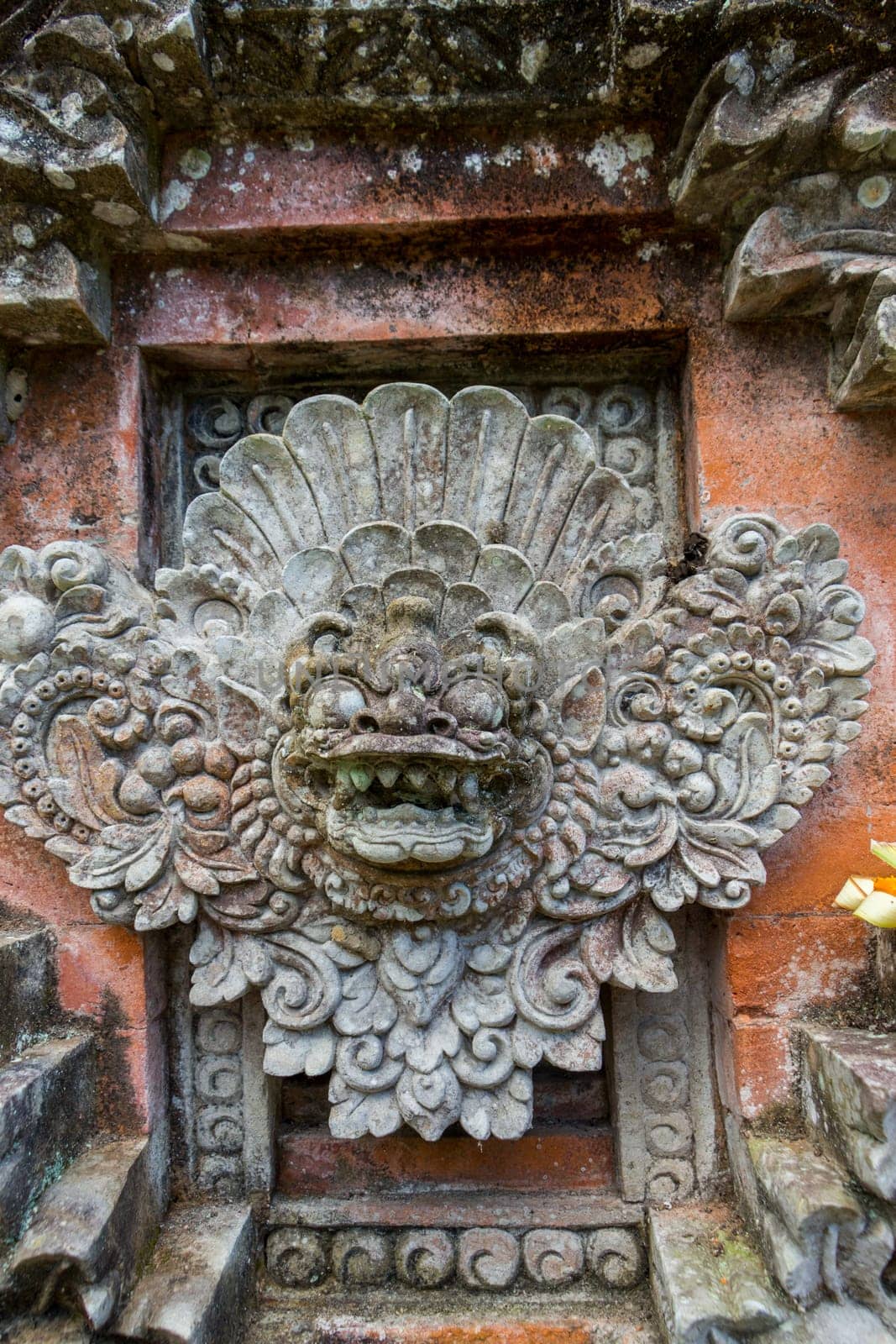 Artful carvings in stone stonemasonry in a green complex in Bali