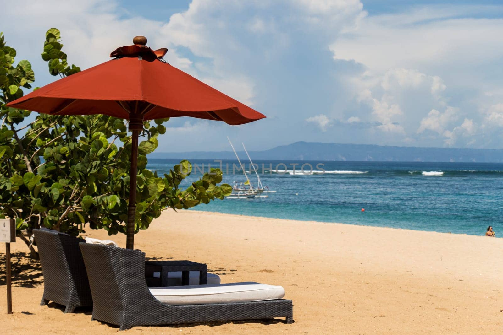 Tropical beach with sun lounger and umbrellas with white sand in the Caribbean
