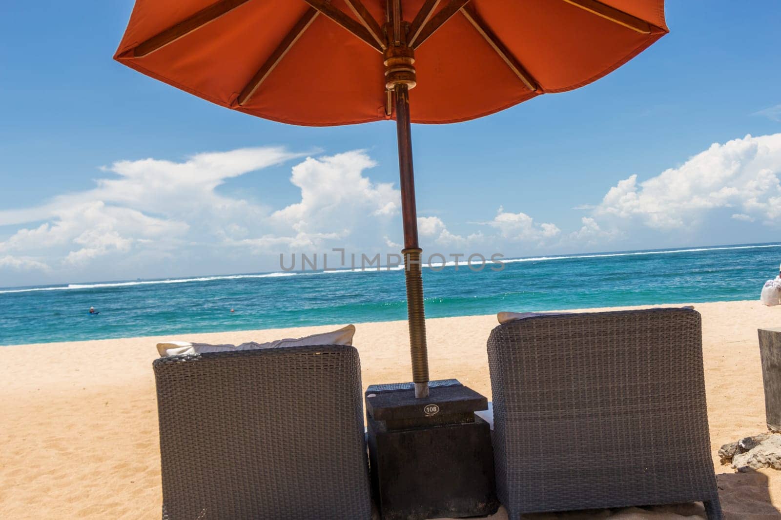 Tropical beach with sun lounger and umbrellas with white sand in the Caribbean