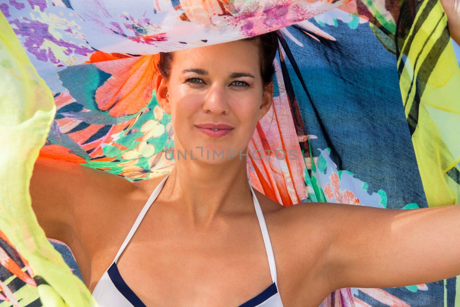 Young pretty woman with dark hair in bikini and Pareo on vacation on the beach portrait