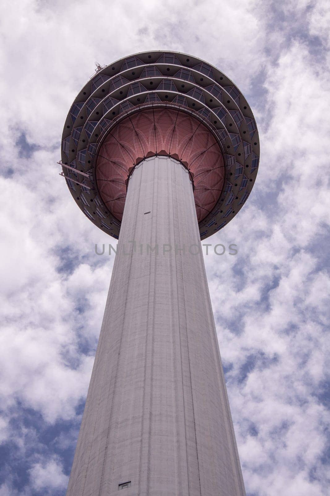 KL Towet in kuala Lumpur Malaysia from below in front of blue sky with clouds