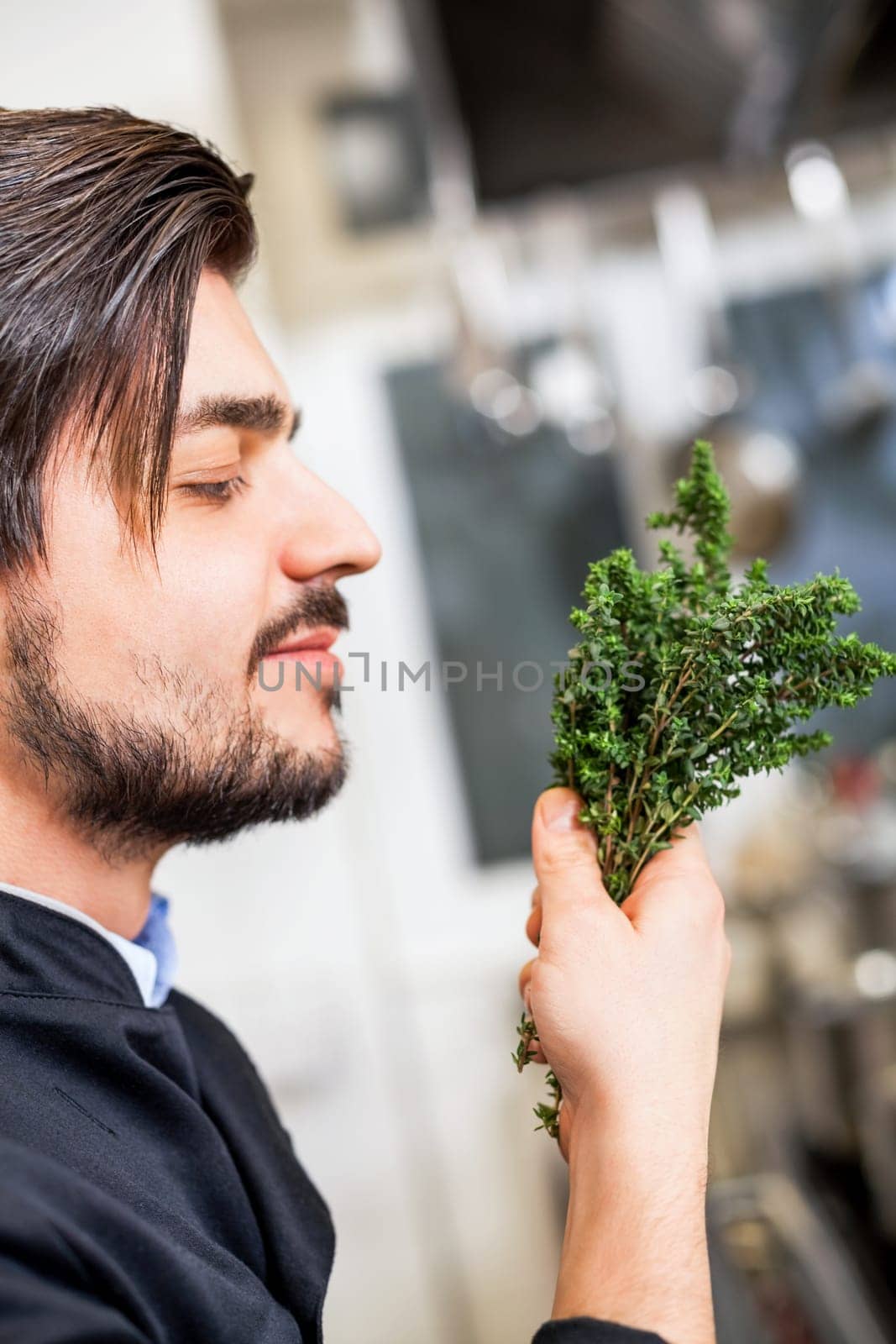 young chef in the restaurant kitchen with fresh arümatic spices