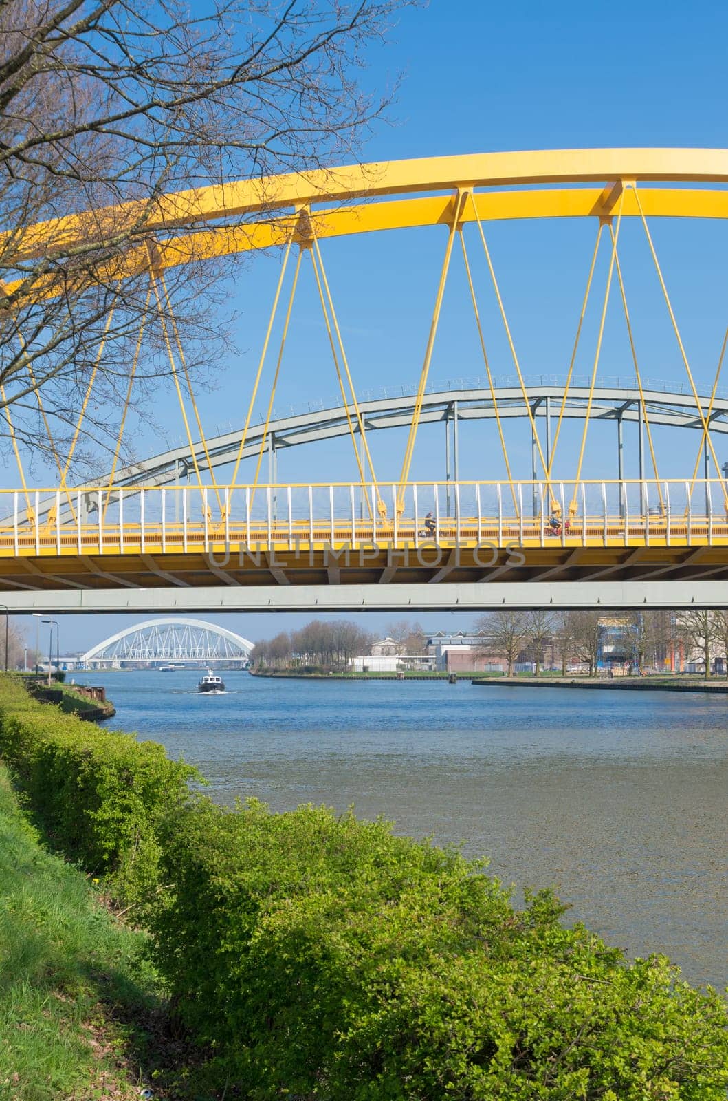 yellow arch bridge in Utrecht, netherlands. The Hogeweide Bridge is a steel arch bridge over the Amsterdam-Rhine Canal