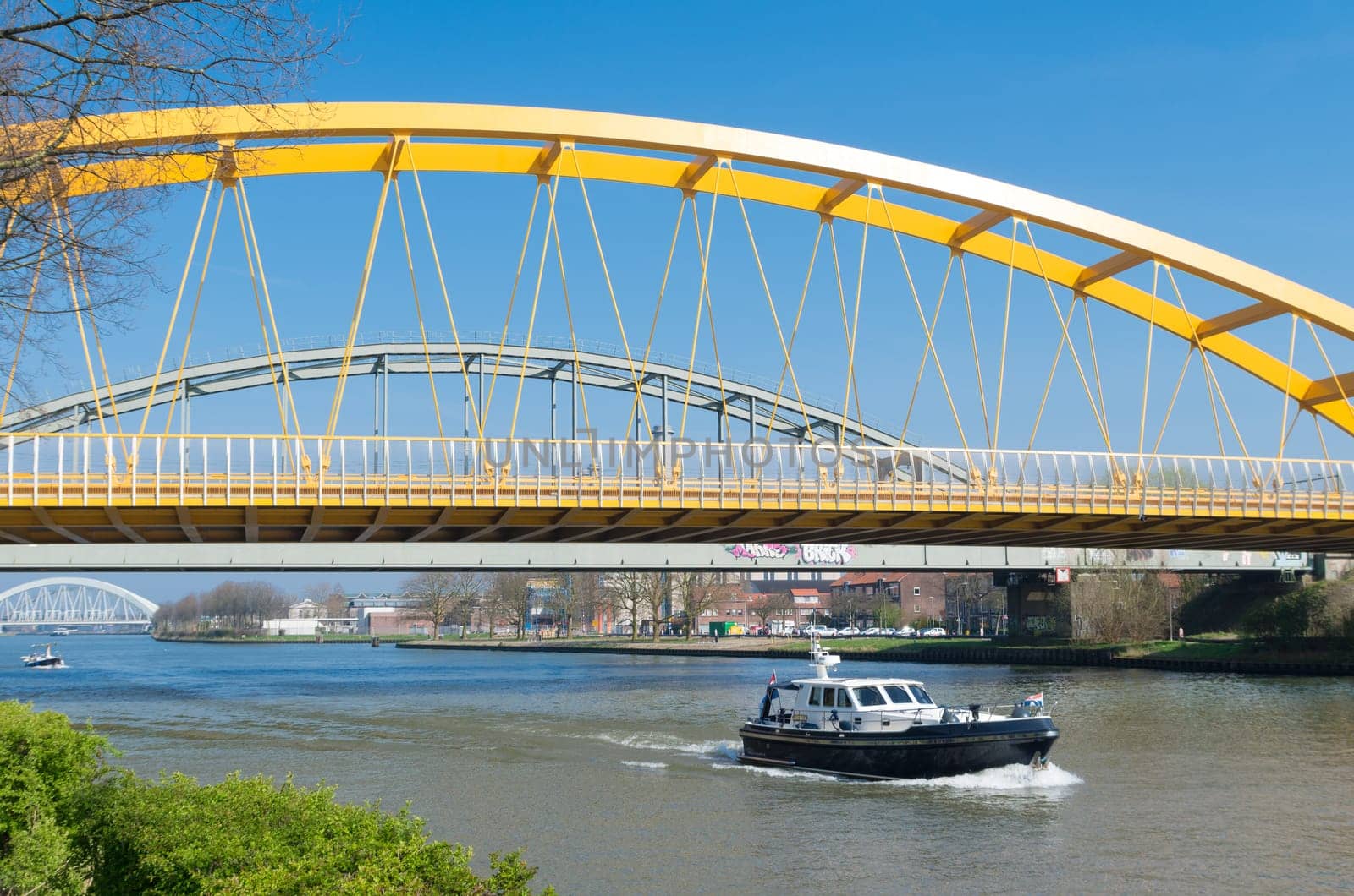 yellow arch bridge in Utrecht, netherlands. The Hogeweide Bridge is a steel arch bridge over the Amsterdam-Rhine Canal