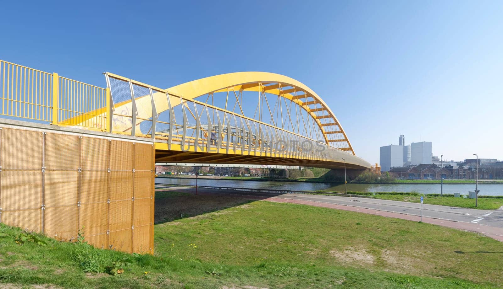 yellow arch bridge in Utrecht, netherlands. The Hogeweide Bridge is a steel arch bridge over the Amsterdam-Rhine Canal