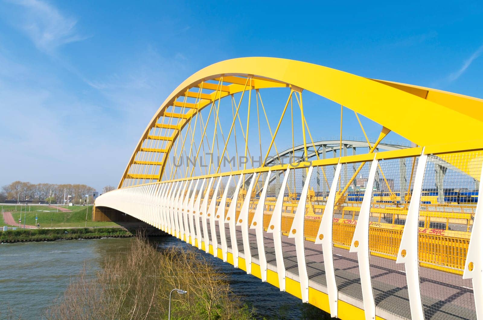yellow arch bridge in Utrecht, netherlands. The Hogeweide Bridge is a steel arch bridge over the Amsterdam-Rhine Canal