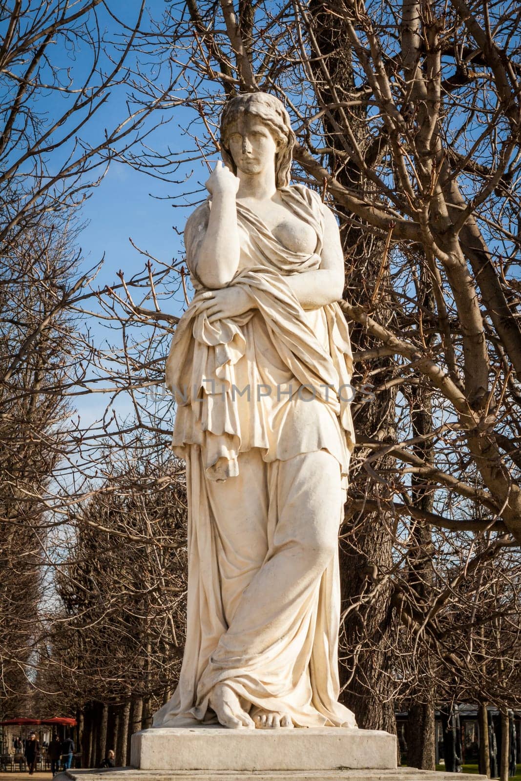 Statue of stone marble carved in front of blue sky in Paris