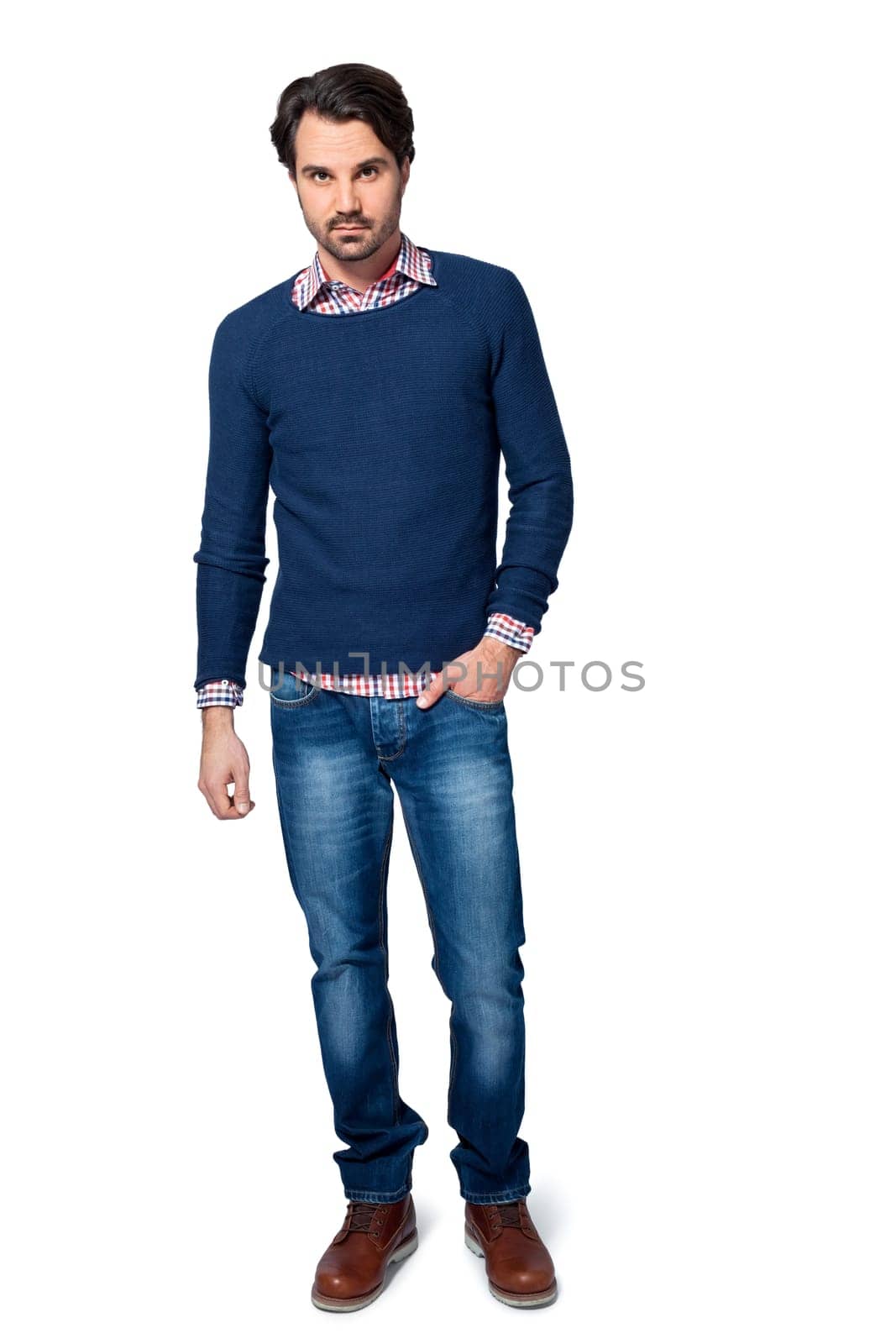 Young man in trendy casual look with dark hair and beard isolated against a white background