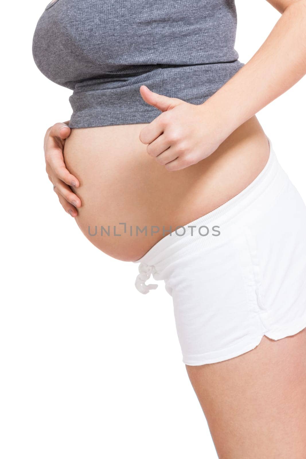 Young woman with baby belly in expectant posture as close-up isolated against white background