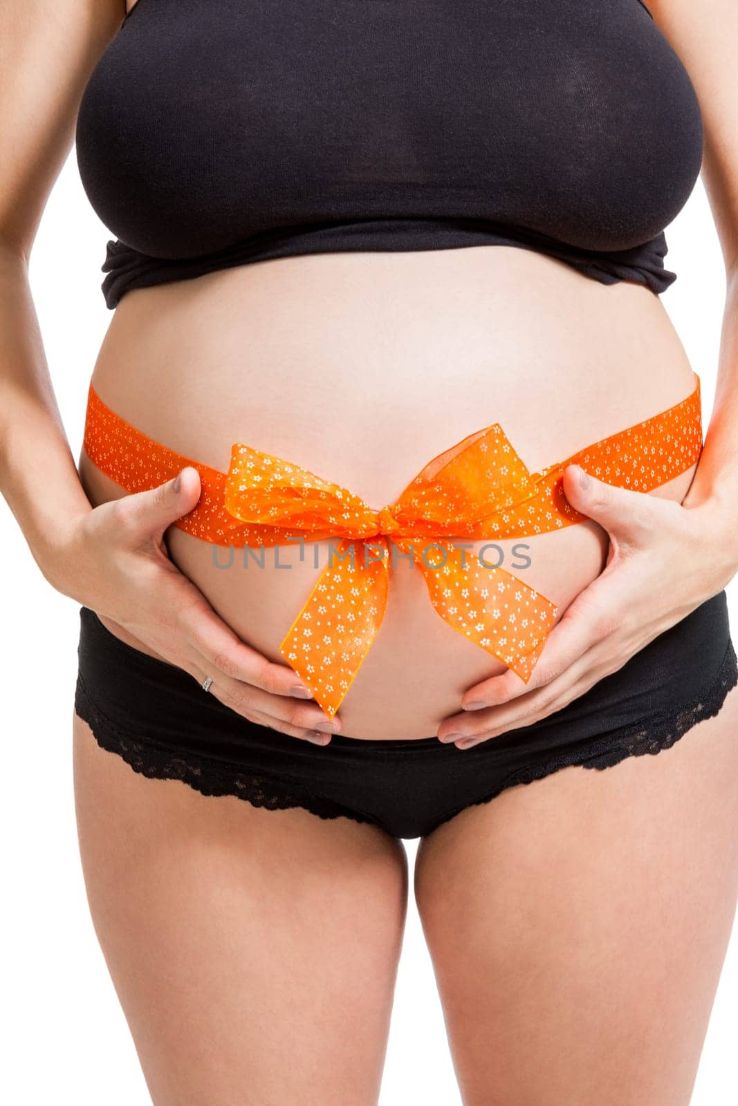 Young pregnant woman with orange bow around her belly as close-up isolated against white background