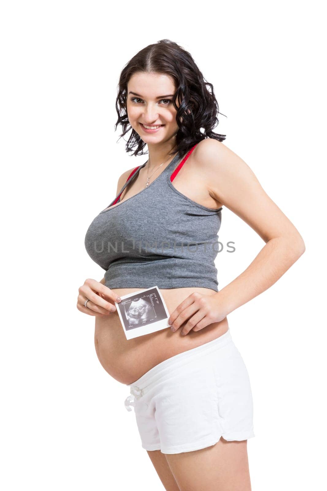 Young attractive woman with ultrasound image in hand pregnant isolated against white background
