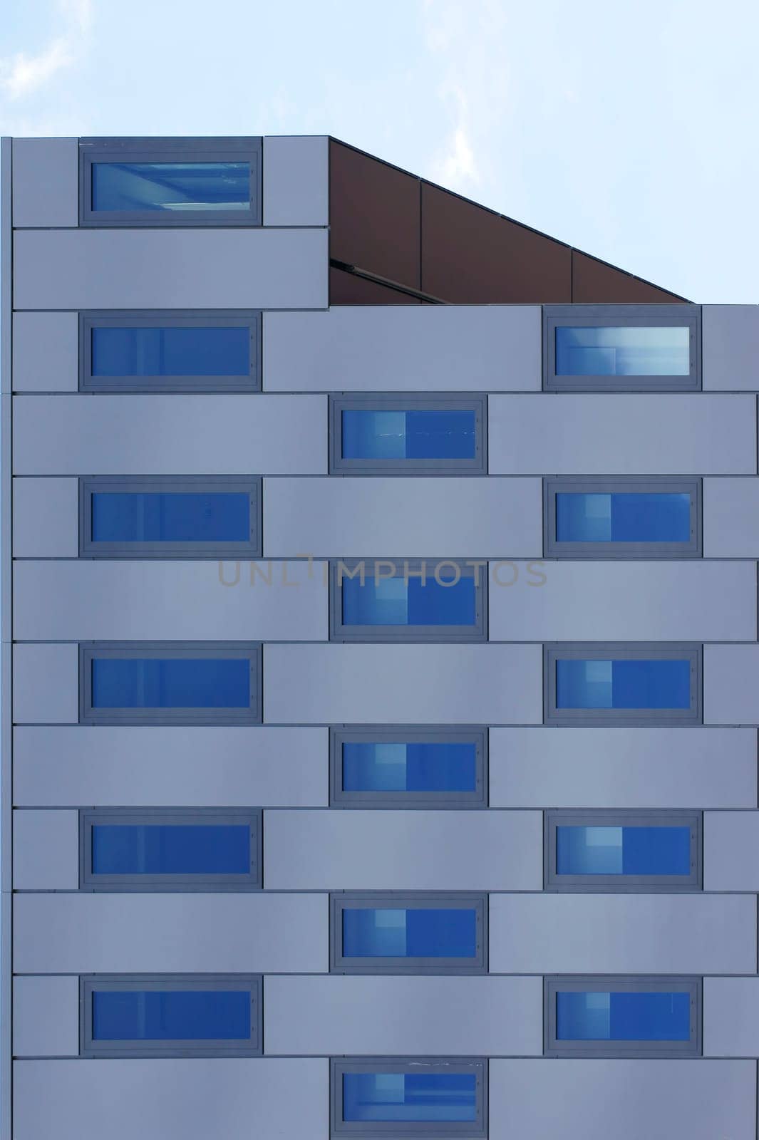 The photograph of an angular,symmetrical and modern building.
