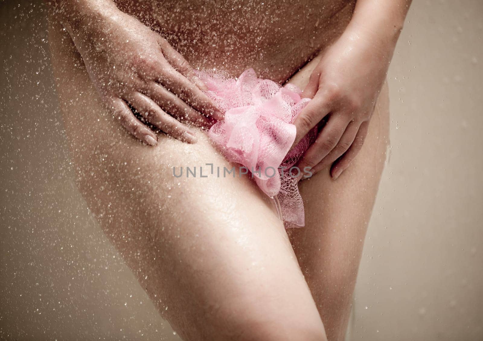 Toned photo of sexy naked woman in shower with pink sponge